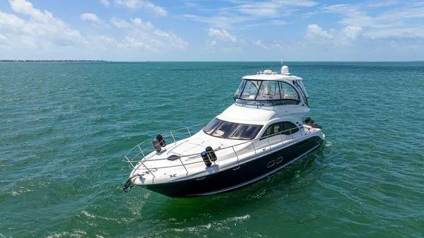  Yacht Photos Pics 2005 Sea Ray 52 Sedan Bridge yacht cruising on open water under clear skies.
