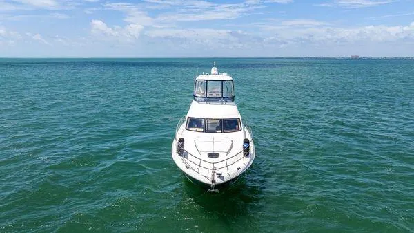  Yacht Photos Pics 2005 Sea Ray 52 Sedan Bridge yacht cruising on open water.