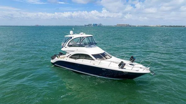  Yacht Photos Pics 2005 Sea Ray 52 Sedan Bridge yacht cruising on open water under a clear sky.
