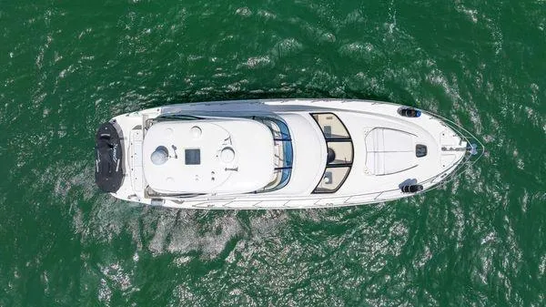  Yacht Photos Pics Aerial view of 2005 Sea Ray 52 Sedan Bridge yacht on green water.