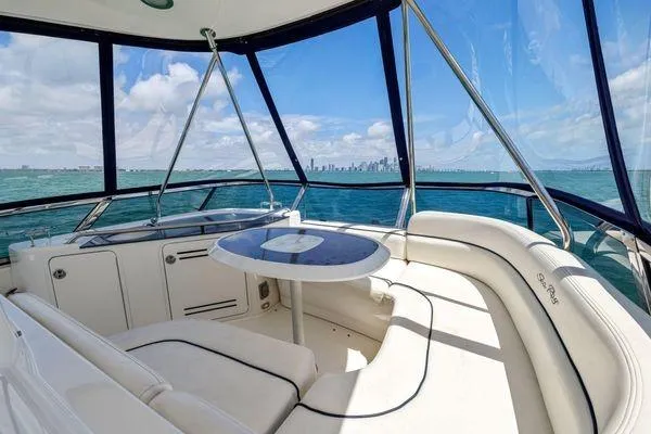  Yacht Photos Pics Luxurious 2005 Sea Ray 52 Sedan Bridge yacht interior with ocean view and city skyline.