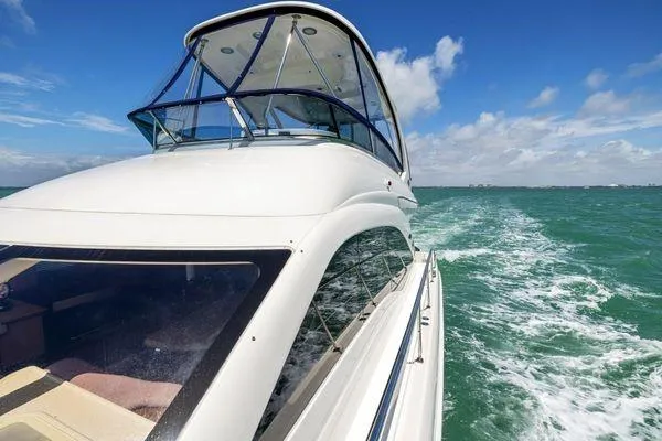  Yacht Photos Pics 2005 Sea Ray 52 Sedan Bridge yacht cruising on open water under clear skies.