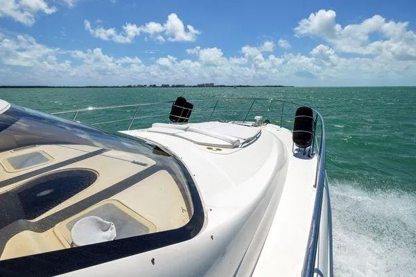 Yacht Photos Pics 2005 Sea Ray 52 Sedan Bridge cruising on open water under a clear blue sky.