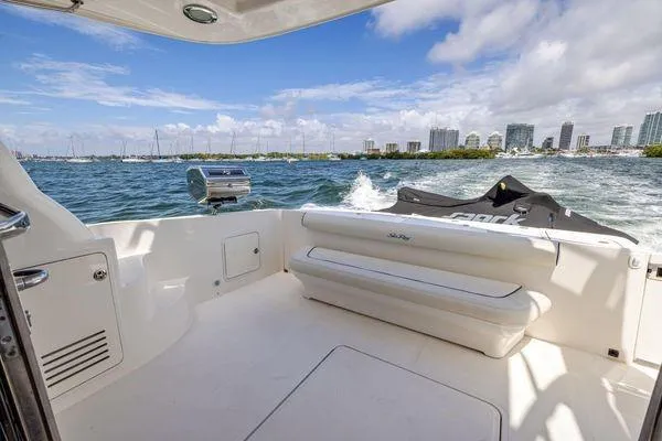  Yacht Photos Pics 2005 Sea Ray 52 Sedan Bridge yacht with city skyline and ocean view.