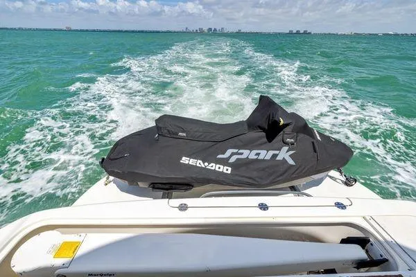  Yacht Photos Pics 2005 Sea Ray 52 Sedan Bridge with Sea-Doo Spark on turquoise water.