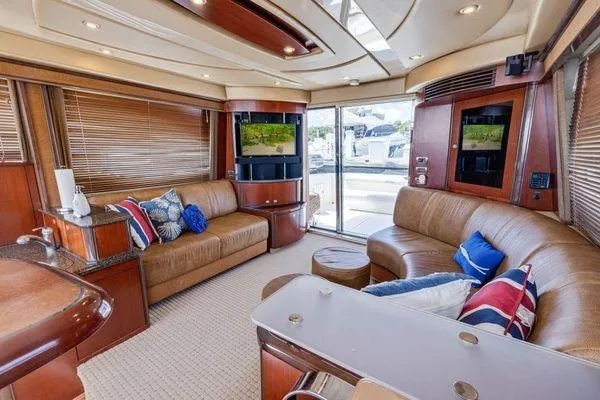  Yacht Photos Pics Luxurious interior of 2005 Sea Ray 52 Sedan Bridge yacht with plush seating and modern amenities.