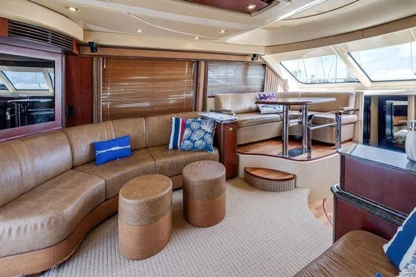  Yacht Photos Pics Luxurious interior of 2005 Sea Ray 52 Sedan Bridge yacht with leather seating and dining area.
