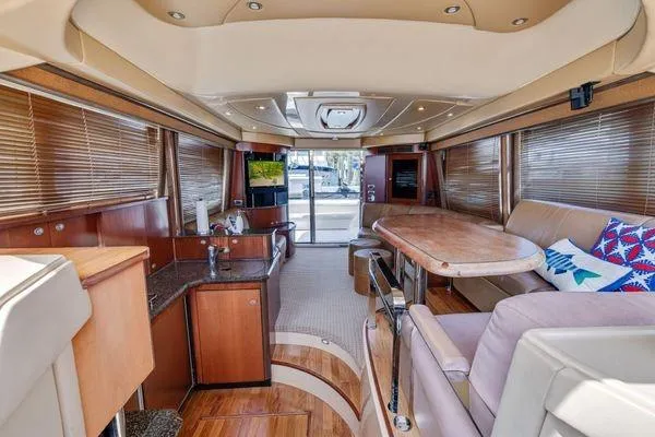  Yacht Photos Pics Luxurious interior of 2005 Sea Ray 52 Sedan Bridge yacht with elegant wood finishes.