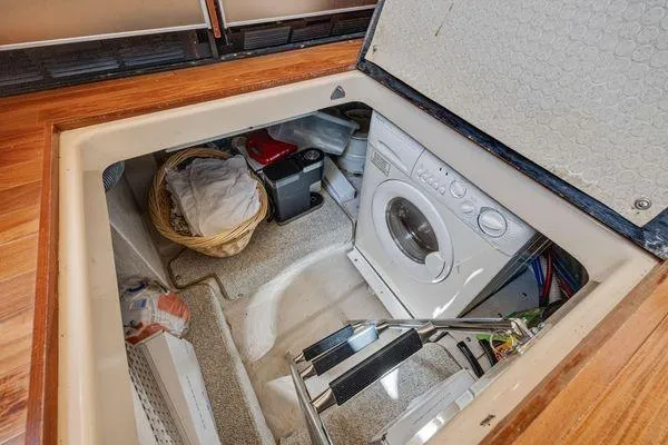  Yacht Photos Pics Laundry area in 2005 Sea Ray 52 Sedan Bridge yacht with washing machine and storage.