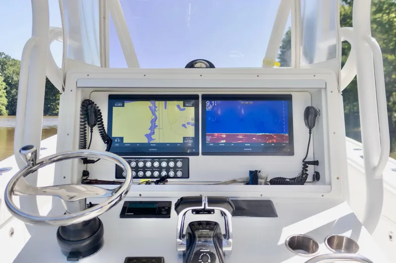  Yacht Photos Pics 2011 Yellowfin 36 Offshore boat dashboard with navigation screens and steering wheel.