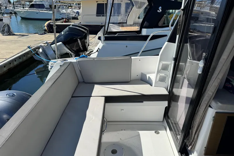  Yacht Photos Pics 2019 Jeanneau NC 895 boat with seating area, docked at marina.