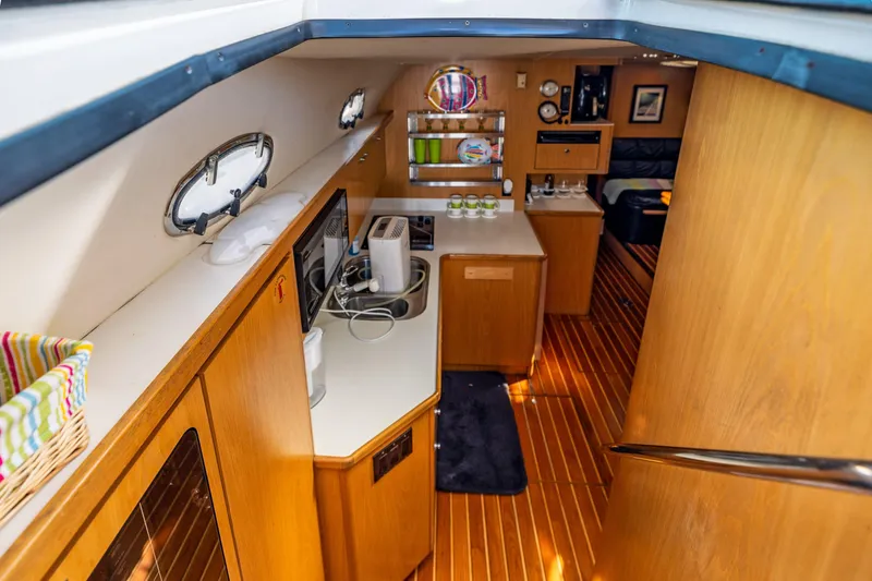  Yacht Photos Pics Interior of 1999 Tiara Yachts 4000 Express with wooden cabinetry and modern appliances.