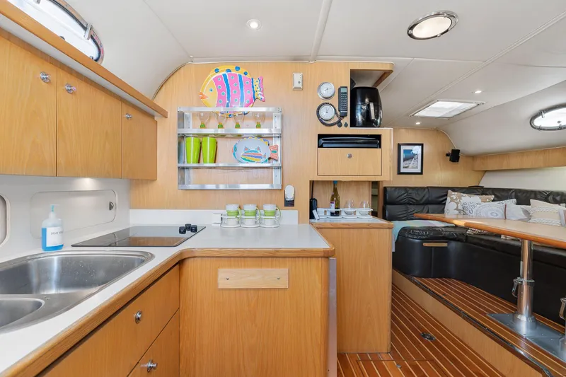  Yacht Photos Pics 1999 Tiara Yachts 4000 Express interior with kitchen and lounge area.