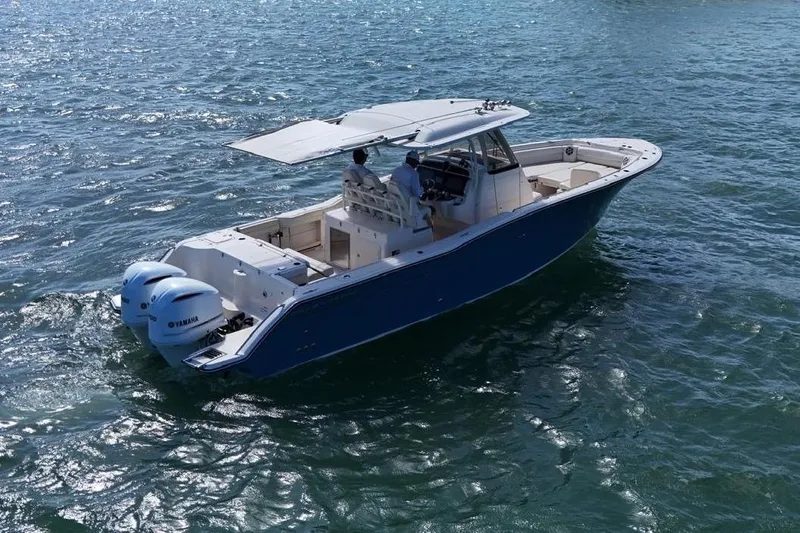  Yacht Photos Pics 2021 Grady-White Canyon 326 boat cruising on open water with dual Yamaha engines.