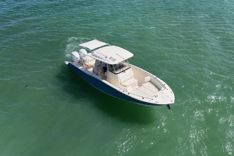  Yacht Photos Pics 2021 Grady-White Canyon 326 boat cruising on clear green water.