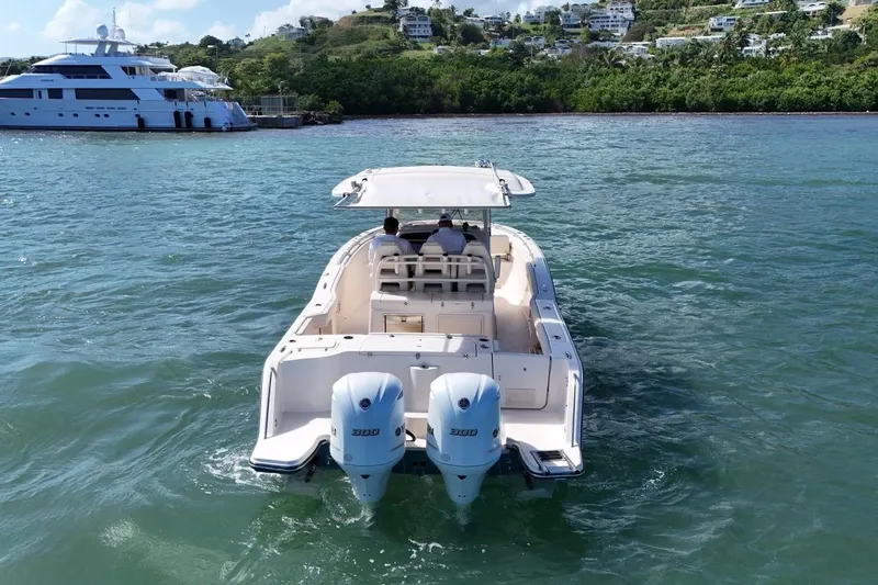  Yacht Photos Pics 2021 Grady-White Canyon 326 boat cruising on clear blue water.