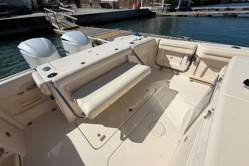  Yacht Photos Pics 2021 Grady-White Canyon 326 boat interior with seating and twin engines at dock.