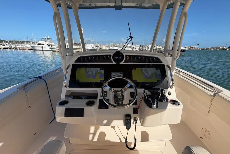  Yacht Photos Pics 2021 Grady-White Canyon 326 boat helm with dual displays, docked in marina.