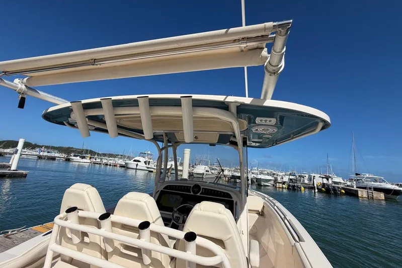  Yacht Photos Pics 2021 Grady-White Canyon 326 boat docked at marina under clear blue sky.
