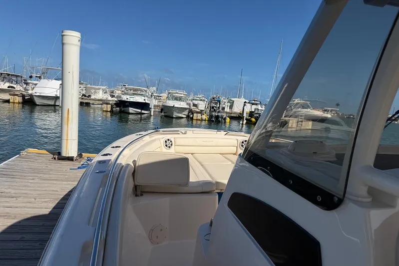  Yacht Photos Pics 2021 Grady-White Canyon 326 boat docked at a marina under clear blue skies.