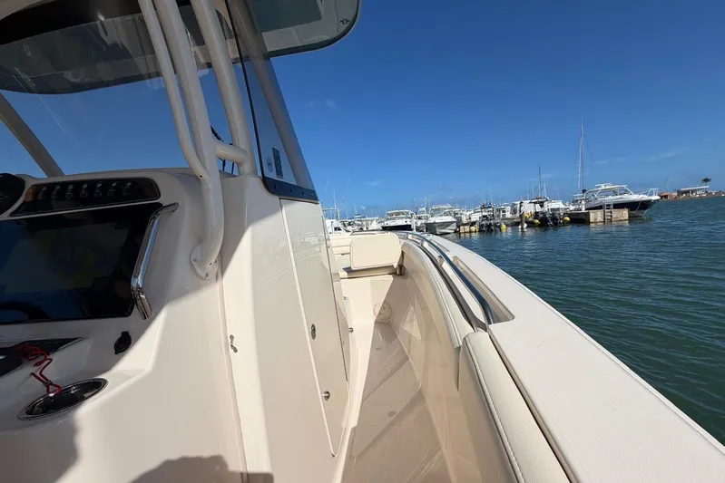  Yacht Photos Pics 2021 Grady-White Canyon 326 boat docked at marina under clear blue sky.