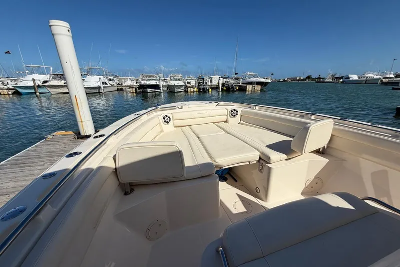  Yacht Photos Pics 2021 Grady-White Canyon 326 boat docked at marina, featuring spacious seating area.