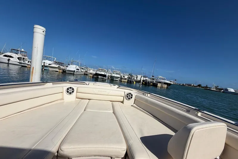  Yacht Photos Pics 2021 Grady-White Canyon 326 boat docked in a sunny marina.