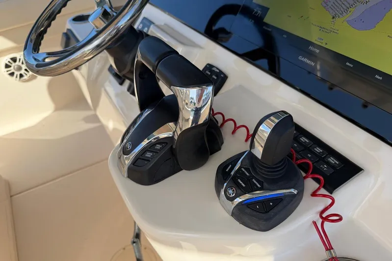  Yacht Photos Pics Control panel of 2021 Grady-White Canyon 326 boat with steering wheel and navigation system.