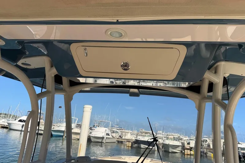  Yacht Photos Pics 2021 Grady-White Canyon 326 boat interior, showcasing helm station and marina view.