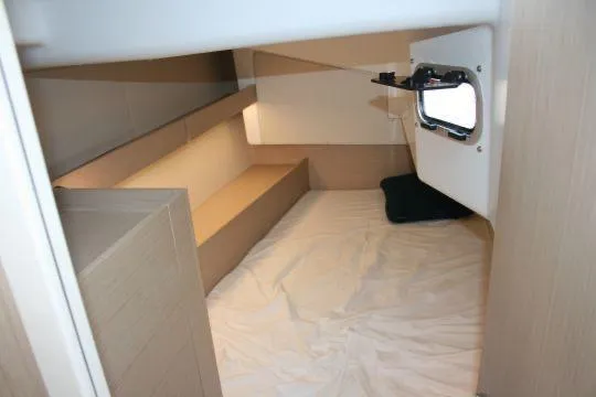  Yacht Photos Pics 2023 Beneteau Oceanis 34.1 cabin interior with bed and window, showcasing modern design.