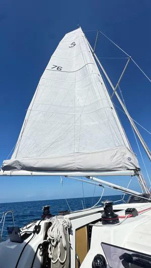  Yacht Photos Pics 2023 Beneteau Oceanis 34.1 sailboat with raised sails against a clear blue sky.
