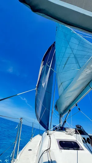 Yacht Photos Pics 2023 Beneteau Oceanis 34.1 sailing on clear blue waters under a bright sky.