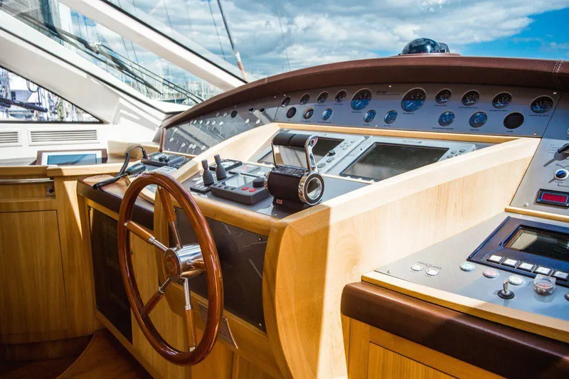  Yacht Photos Pics Cockpit of 2008 Dalla Pieta 80 yacht with wooden steering wheel and control panel.
