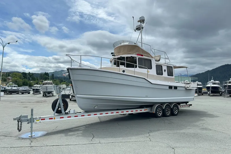  Yacht Photos Pics 2025 Ranger Tugs R-31 CB boat on trailer in marina parking lot.