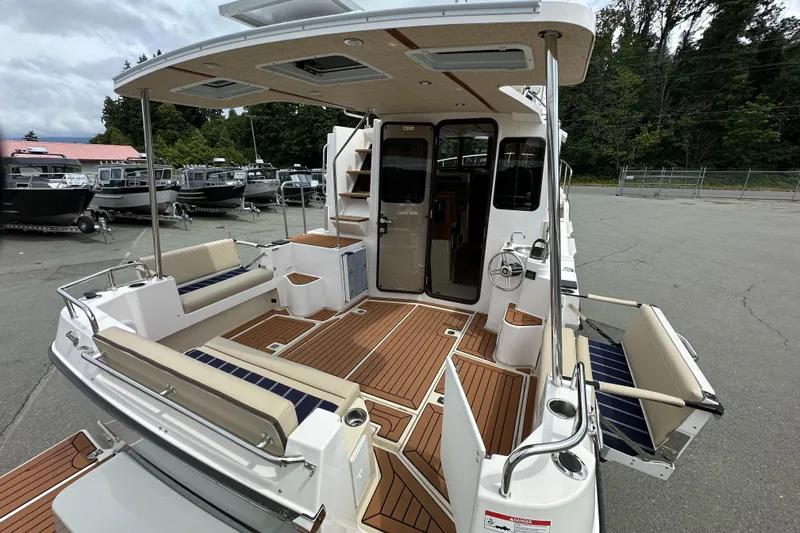 Yacht Photos Pics 2025 Ranger Tugs R-31 CB boat with spacious deck and seating, docked outdoors.