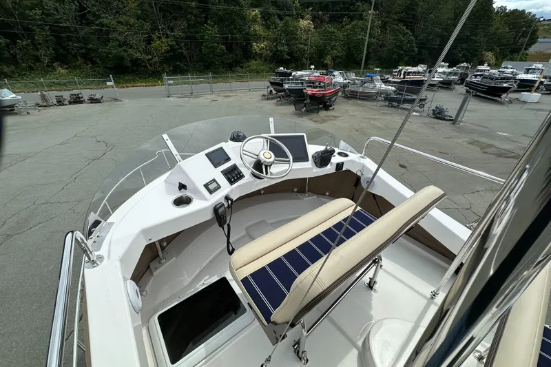  Yacht Photos Pics 2025 Ranger Tugs R-31 CB boat helm with dual seating and navigation controls.
