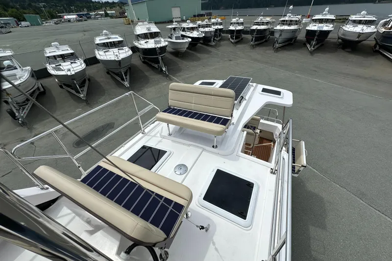  Yacht Photos Pics 2025 Ranger Tugs R-31 CB boat with solar panels, docked among other vessels.