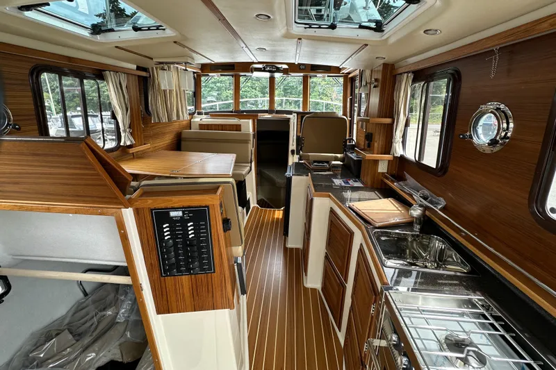  Yacht Photos Pics Interior of 2025 Ranger Tugs R-31 CB, featuring wood accents and modern amenities.