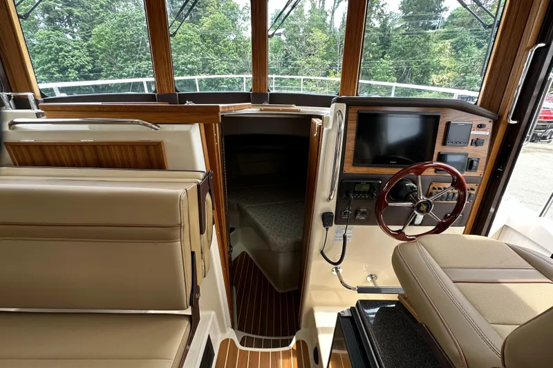  Yacht Photos Pics 2025 Ranger Tugs R-31 CB interior with helm, seating, and navigation equipment.