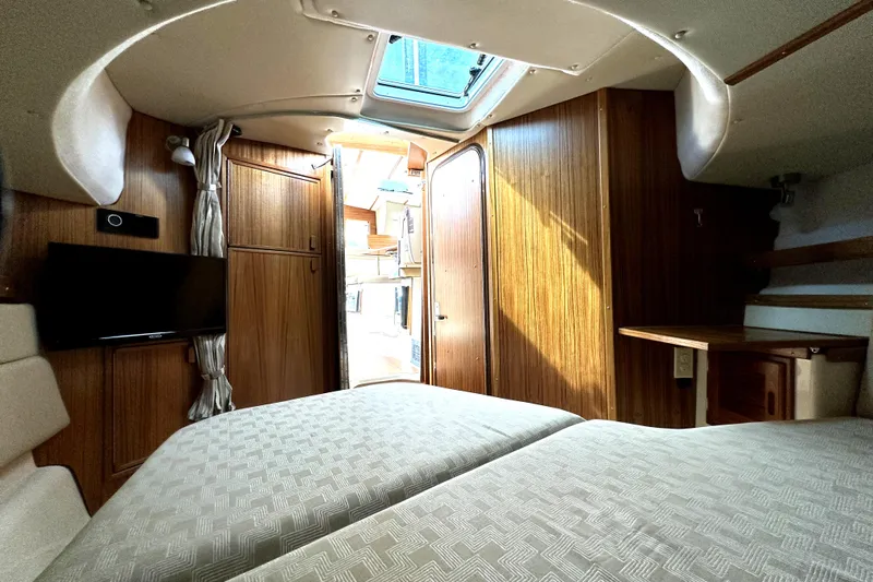  Yacht Photos Pics Interior of 2025 Ranger Tugs R-31 CB, featuring cozy cabin with wood paneling and skylight.