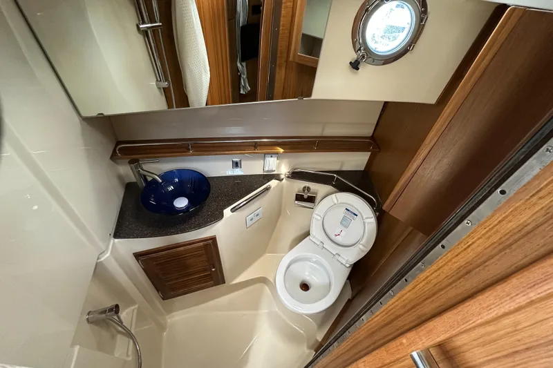  Yacht Photos Pics Luxurious bathroom in 2025 Ranger Tugs R-31 CB with modern fixtures and wood accents.
