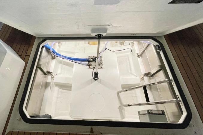 Open hatch of 2027 Schaefer V34 boat showing interior storage compartment.