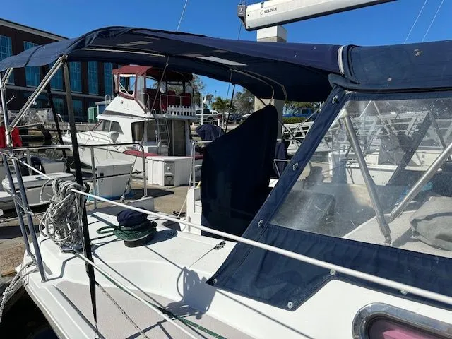 Junebug Yacht Photos Pics 2008 Catalina 350 MkII sailboat docked, featuring blue canopy.