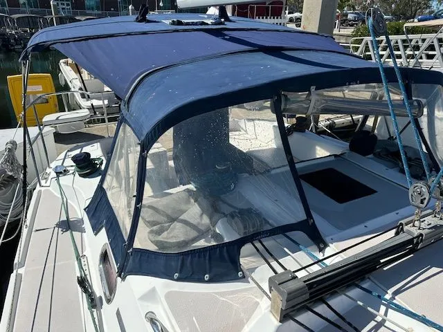 Junebug Yacht Photos Pics 2008 Catalina 350 MkII sailboat with blue cover in harbor.