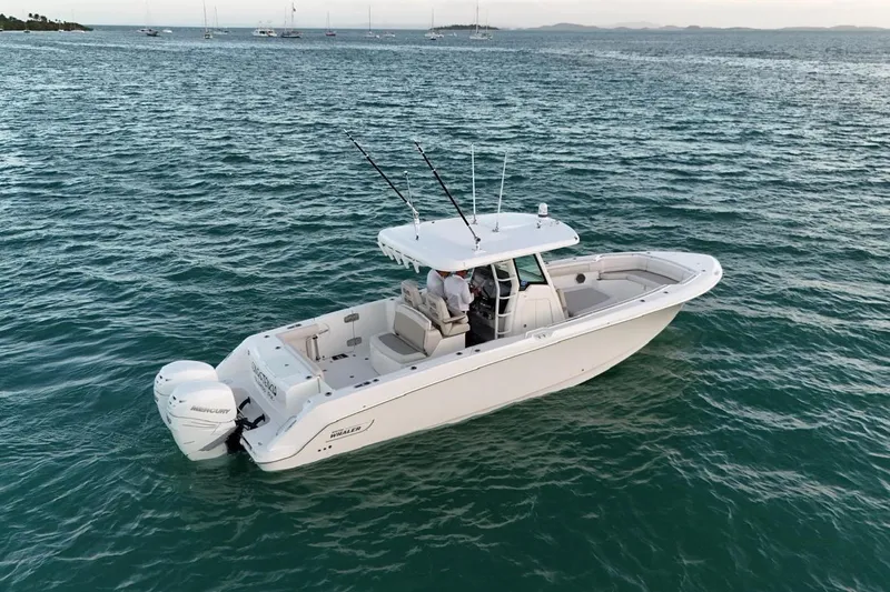  Yacht Photos Pics 2017 Boston Whaler 330 Outrage boat on calm ocean waters.