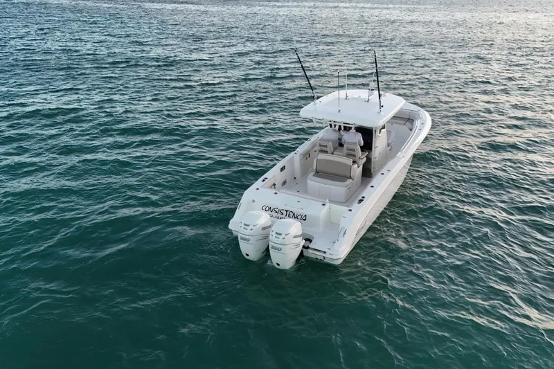  Yacht Photos Pics 2017 Boston Whaler 330 Outrage boat on open water, rear view with twin engines.