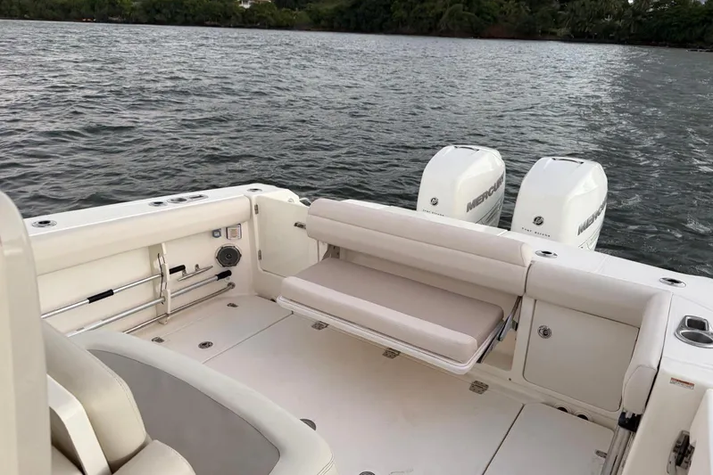  Yacht Photos Pics 2017 Boston Whaler 330 Outrage boat with dual Mercury engines on a calm waterway.