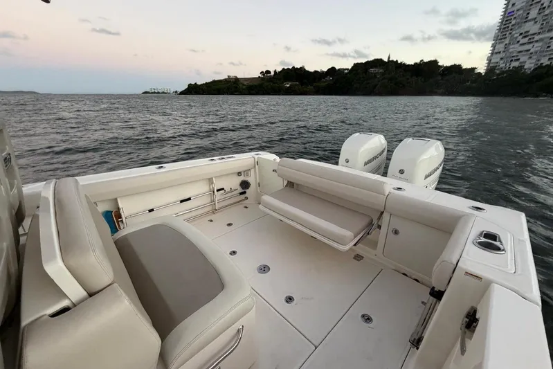  Yacht Photos Pics 2017 Boston Whaler 330 Outrage boat with dual engines on calm water at sunset.