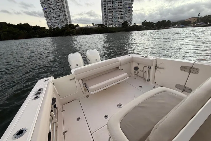  Yacht Photos Pics 2017 Boston Whaler 330 Outrage boat interior with dual engines, near waterfront buildings.