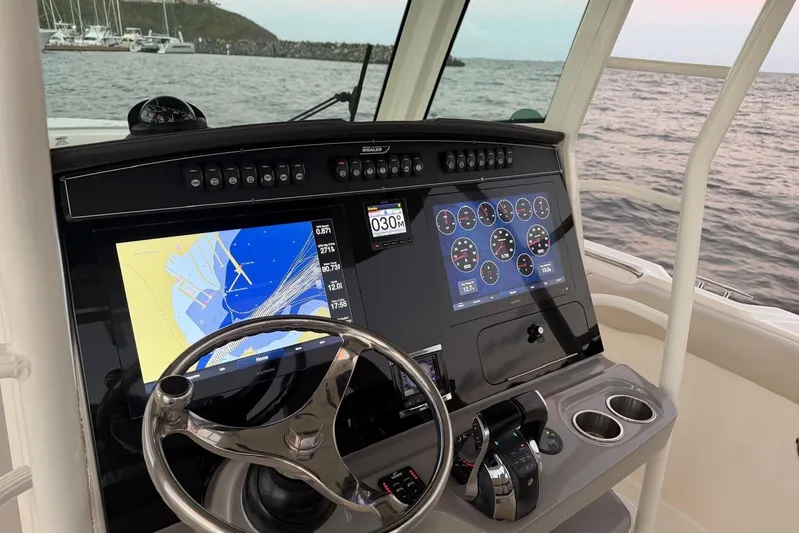  Yacht Photos Pics Boston Whaler 330 Outrage 2017 dashboard with navigation screens and steering wheel.